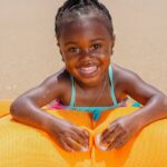 Every time you’ve been to the beach or a public pool, you’ve probably seen little ones running around joyously with water wings firmly around both arms. Floaties are such a common sight, many parents don’t even think to question them. Everyone uses them, so they must be OK, right? But are arm floaties safe? According to swim experts, no! Here are the top seven reasons why not: