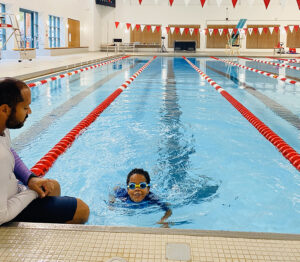 parent with child in pool